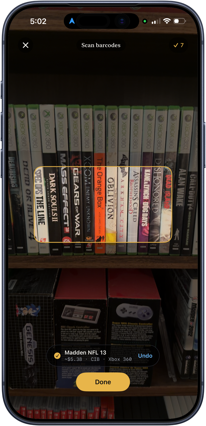 Scanning a shelf of game cases with Plynt on an iPhone, each one added with its value